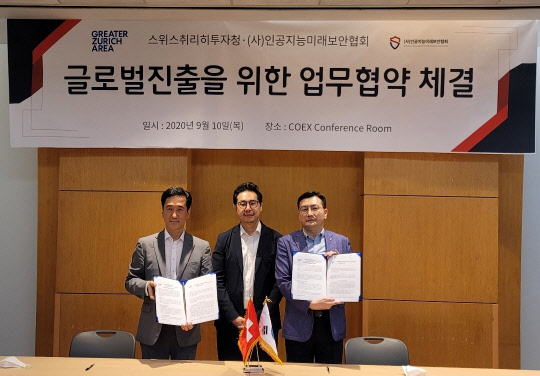 채정우 (사)인공지능미래보안협회장(우)이 스위스취리히투자청 김주현 한국 대표(좌)와 MOU를 체결하고 기념사진을 촬영하고 있다. 가운데는 ㈜페르소나에이아이 유승재 대표.